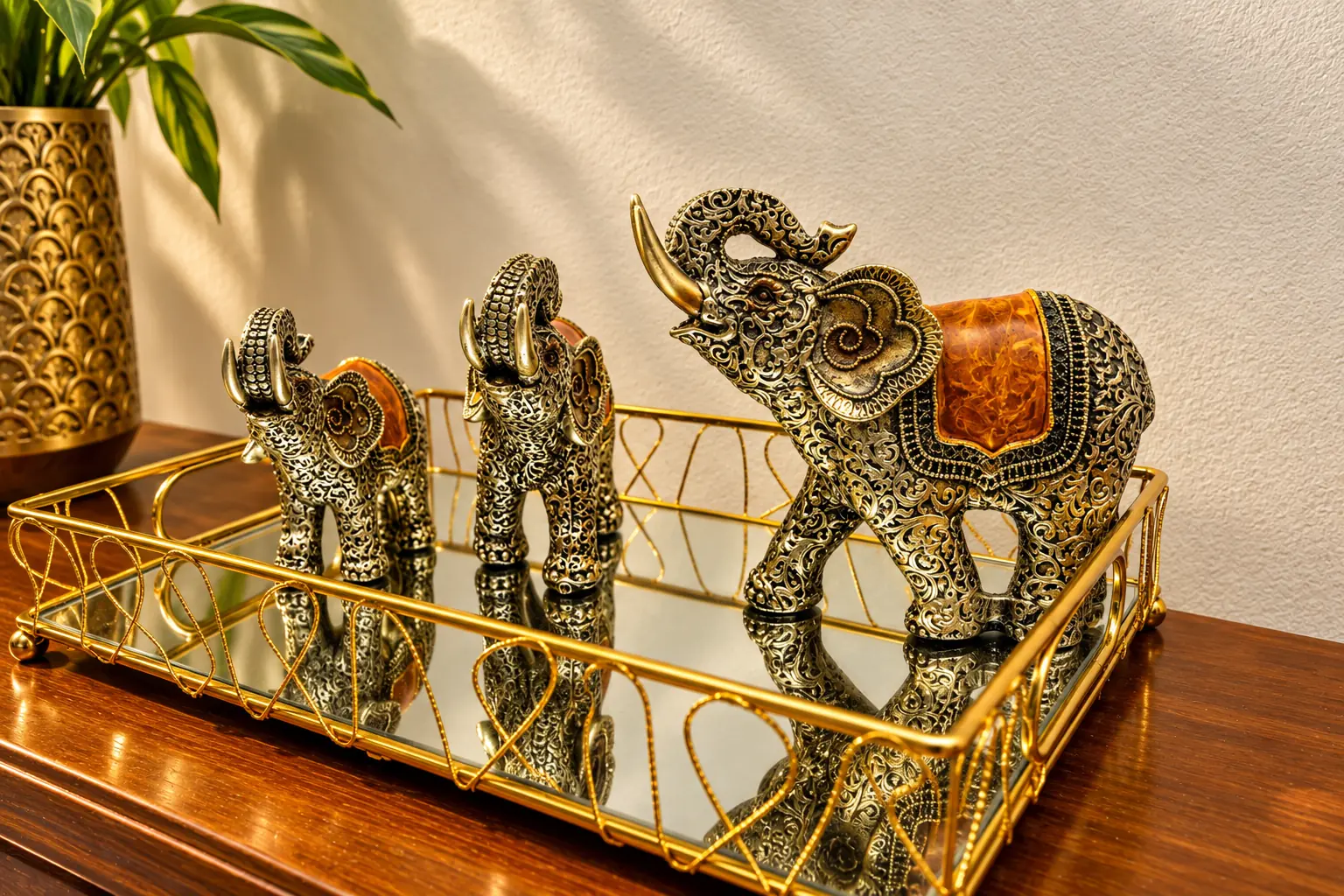 Brass elephants on a mirrored tray